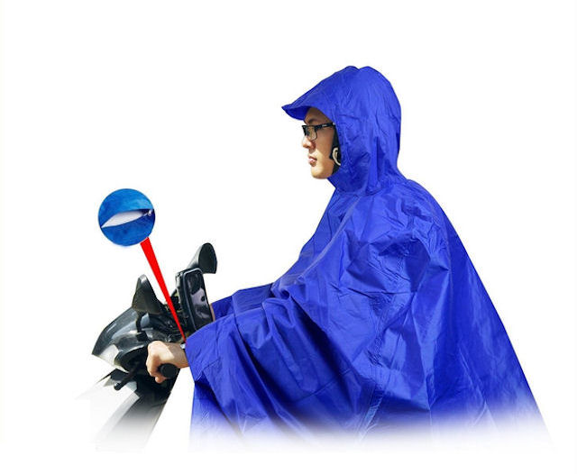 Person wearing poncho on mobility scooter